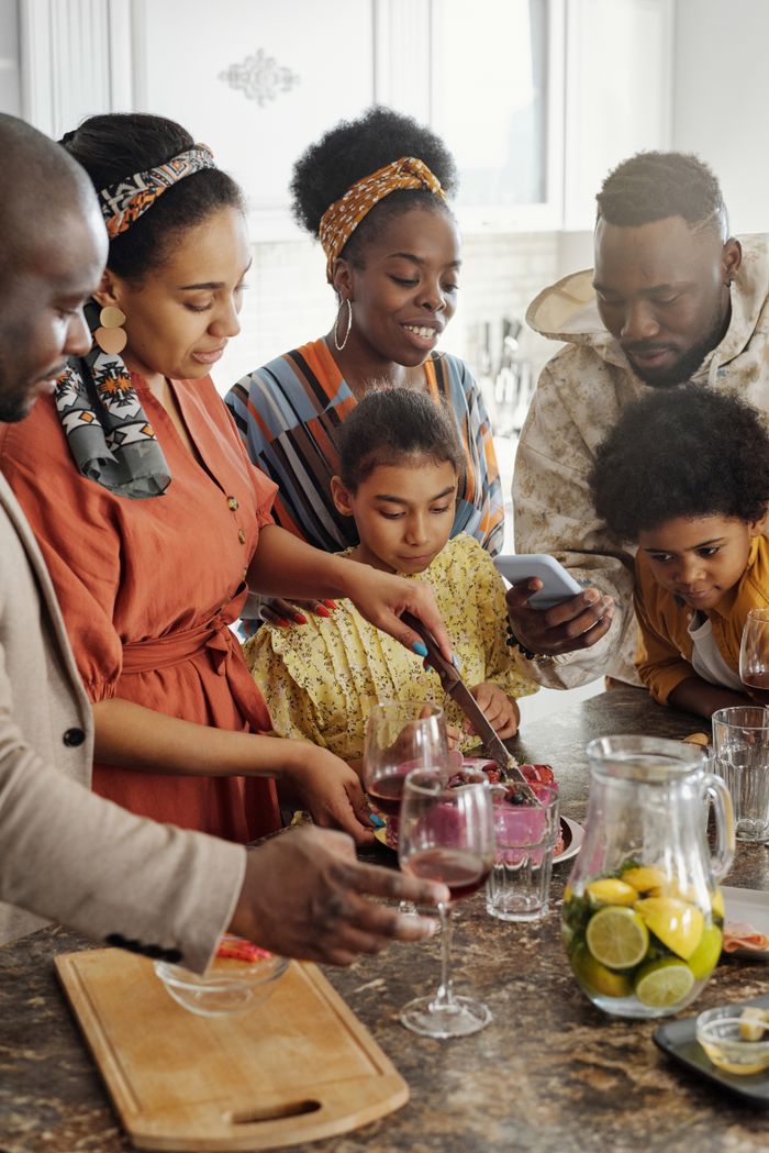A joyful family celebration with a birthday cake indoors, capturing happiness and togetherness.